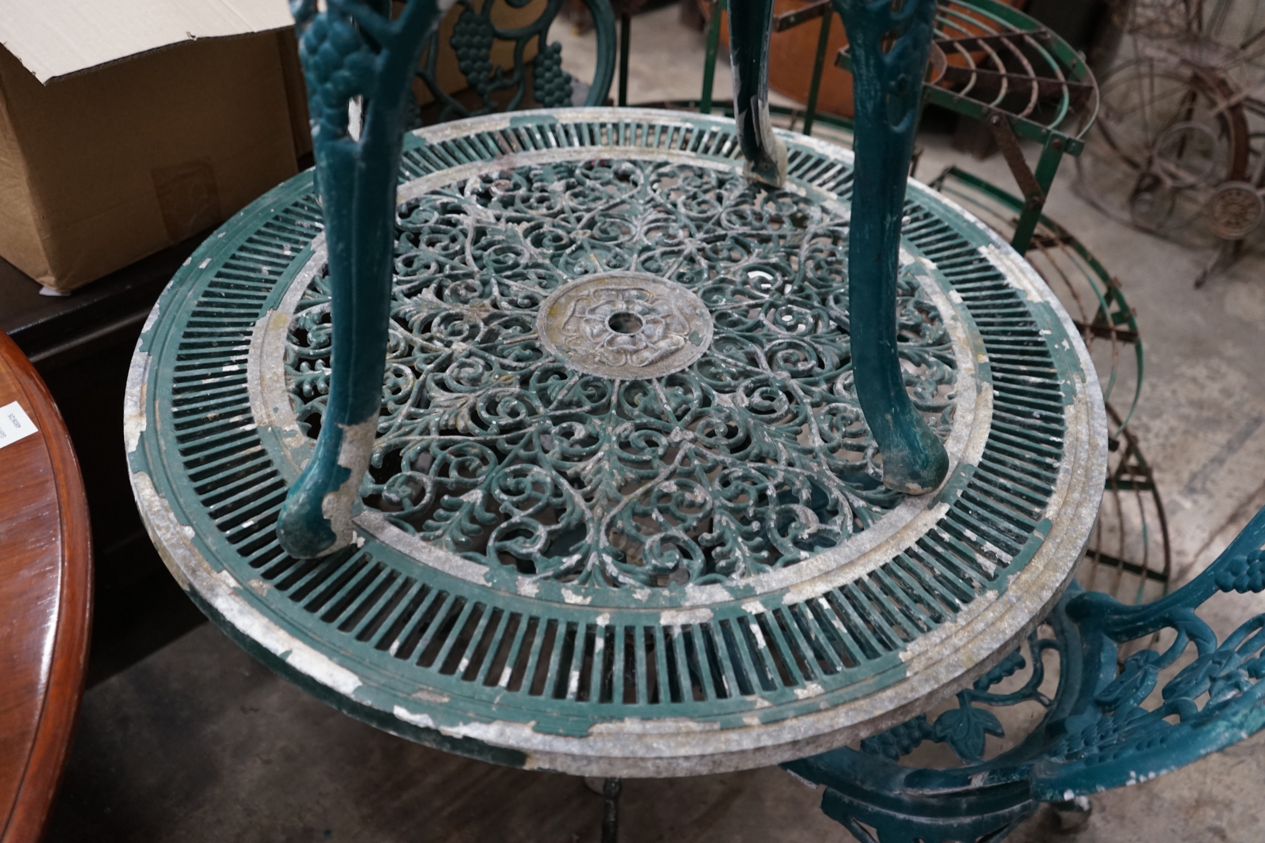 A circular painted aluminium garden table and three chairs, table diameter 79cm height 67cm